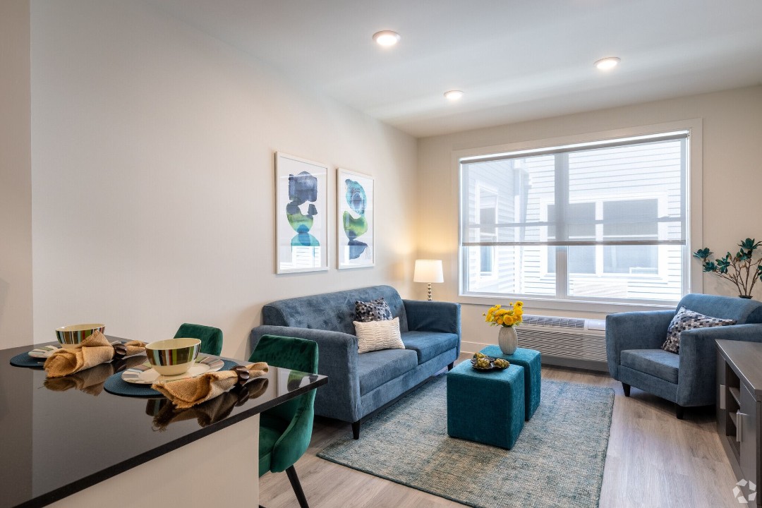 Open-concept living room with modern furniture and large windows