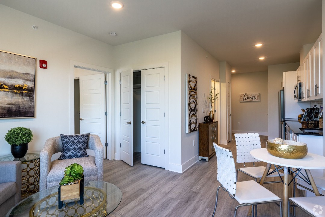 Living and dining area with walk-in closet and open kitchen layout